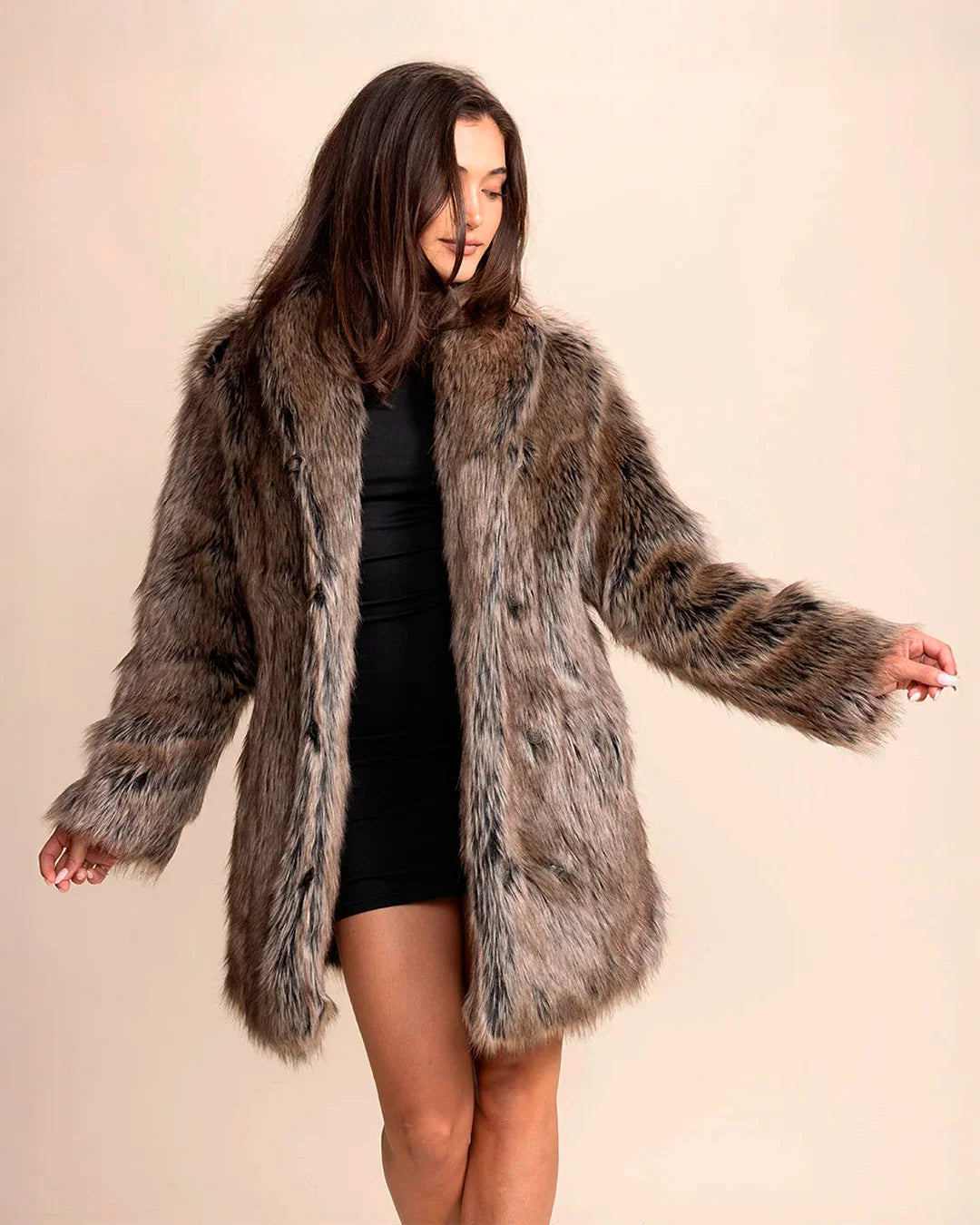 Woman wearing a SpiritHoods Dire Wolf Faux Fur coat against a plain background