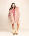 Sustainable luxury: a pink shaggy fake fur coat for women made from 100% cruelty-free materials with limited waste production.