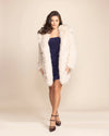 Sustainable Luxury: a white wolf fake fur coat for women made from 100% cruelty-free materials with plush texture.