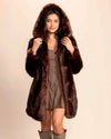 SpiritHoods Women's Faux Fur Coat in brown wolf fake fur. Hooded luxury vegan fake fur jacket styled with a brown mini-dress and fall boots.