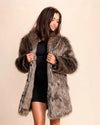 Woman wearing a  vegan fake fur parka jacket perfect for music festivals and fall layering on a beige background
