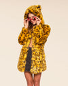 Animal-inspired vegan fashion brand coat in yellow cheetah print, perfect for bold festival outfits 