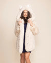Woman wearing an Arctic Wolf Classic white faux fur coat with an oversized hood and wolf ears.