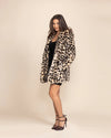 Woman wearing a SpiritHoods Oncilla leopard print faux fur coat with an oversized collar and relaxed fit.