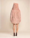 Women's warm blush rose alpaca style vegan fur layering piece with an oversized hood, perfect for top-rated festival fashion