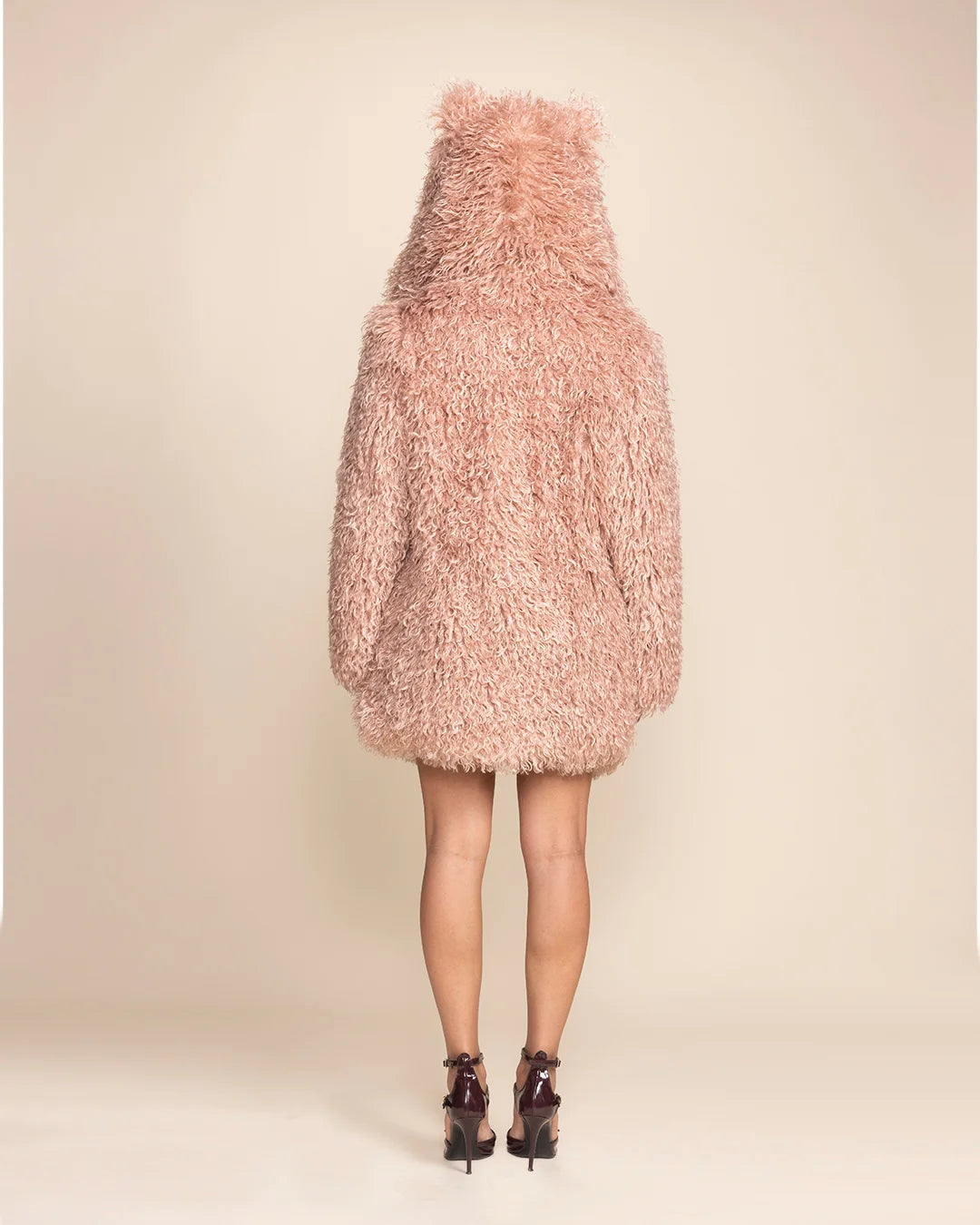 Women's warm blush rose alpaca style vegan fur layering piece with an oversized hood, perfect for top-rated festival fashion