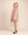 Modern women's Streetwear featuring a shaggy pink faux fur coat with peacoat button closure and oversized hood.
