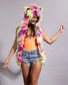 UV blacklight glow faux fur festival hood with vibrant neon pink, lime green, and bright purple reactive fur.