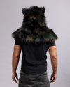 A person shown from the back wearing a large furry shawl with animal-like ears, over a black T-shirt and gray pants, against a plain light gray studio background.