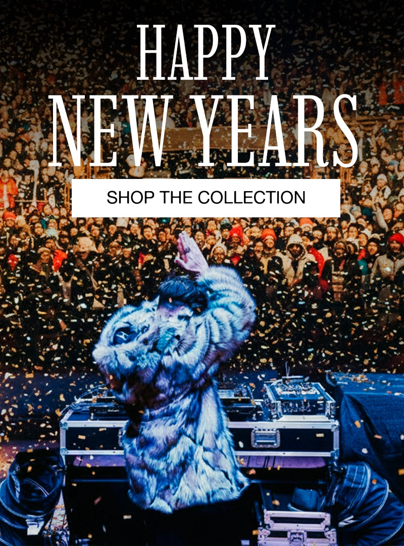 A DJ in front of a huge crowd wearing SpiritHoods' "Wolverine" faux fur coat and text 'Happy New Years! Shop the Collection' overlay.