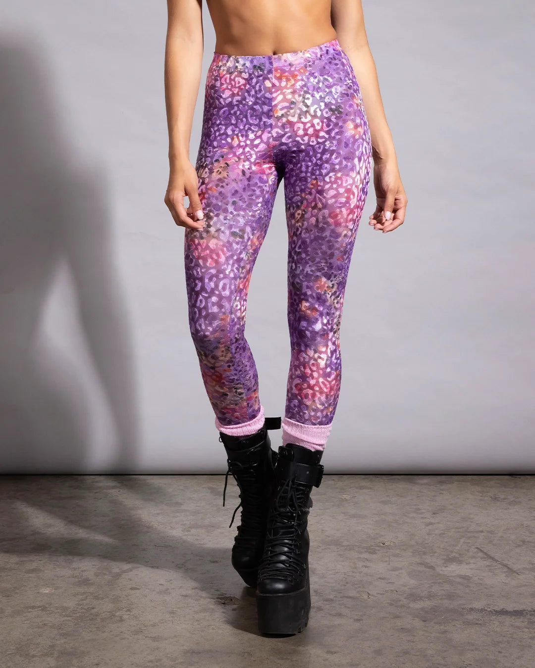 Purple and pink leopard print mesh leggings by SpiritHoods, designed for breathable rave wear and active dancing.