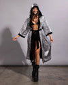Woman smiling in a silver snakeskin sequin festival kimono featuring a lightweight draped silhouette and cozy hood.
