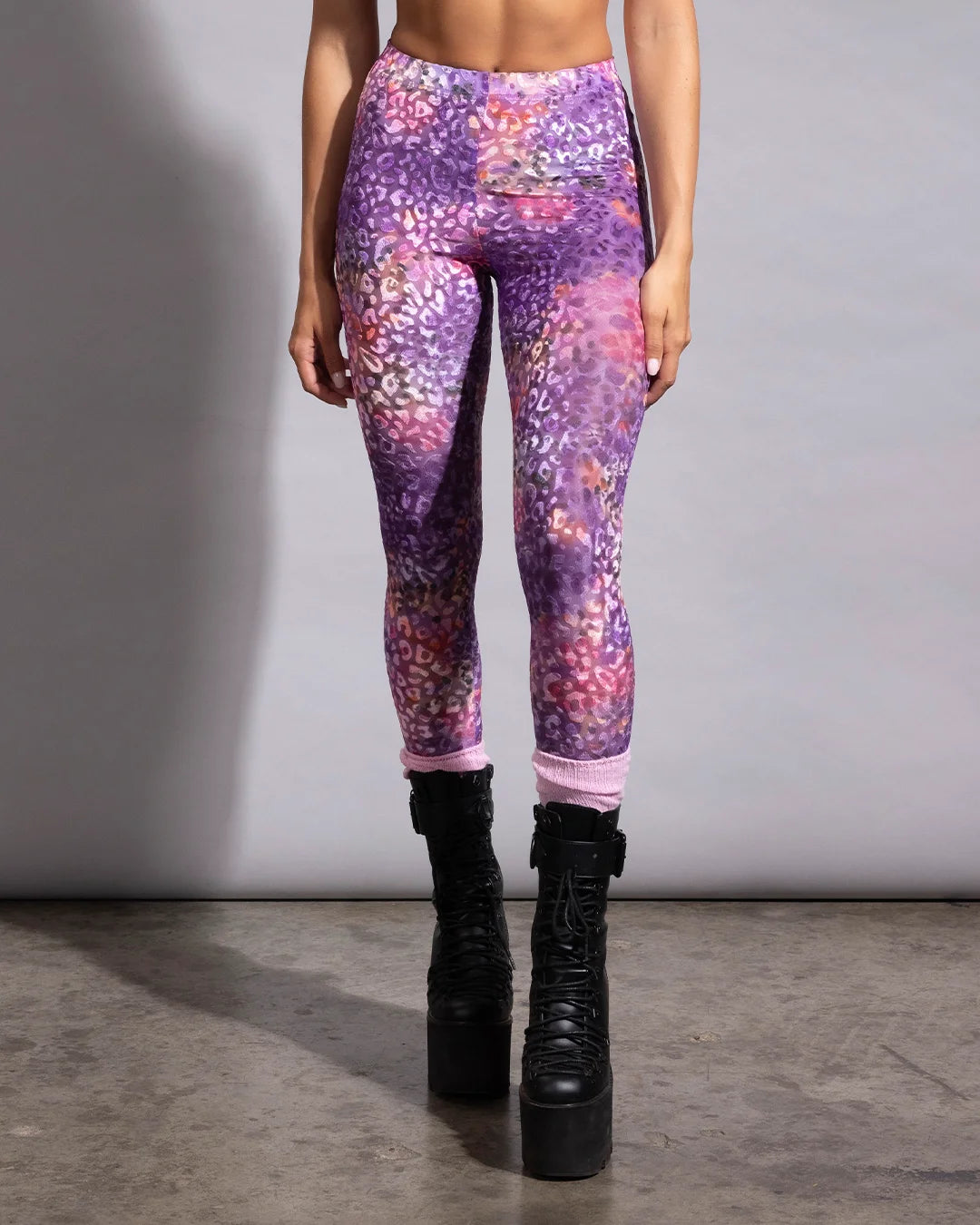 Detail view of a woman in SpiritHoods sheer leopard print tights highlighting the form-fitting, stretchy fabric blend.