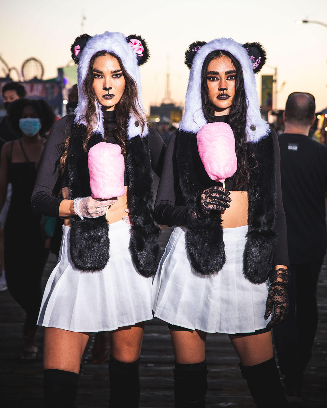 SpiritHoods Panda Bear Halloween Costume Inspiration Two Girls Eating Cotton Candy At the Pier Wearing SpiritHoods Panda Bear Fake Fur Hoods - With Painted on Nose and Black Lipstick