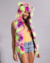 Top-rated festival fashion: a woman wearing a neon cat ears faux fur headpiece with ultra-bright multi-colored fur.