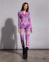Full-length view of a women's tie-dye leopard burnout velvet bodysuit, styled for electronic music festivals.