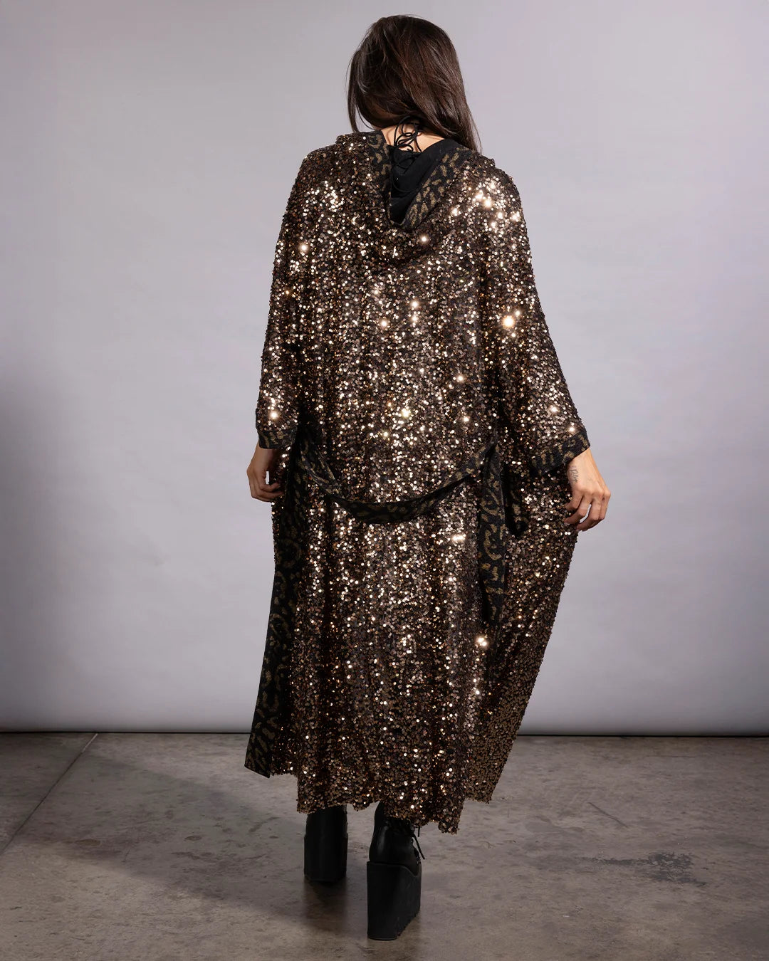 Lightweight gold sequin hooded kimono paired with black platform rave boots for festival fashion inspiration.
