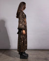 view of a women's gold sequin festival outerwear piece highlighting the detailed sequins and shine