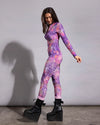 SpiritHoods burning velvet sheer catsuit featuring a vibrant purple and pink tie-dye leopard print pattern.