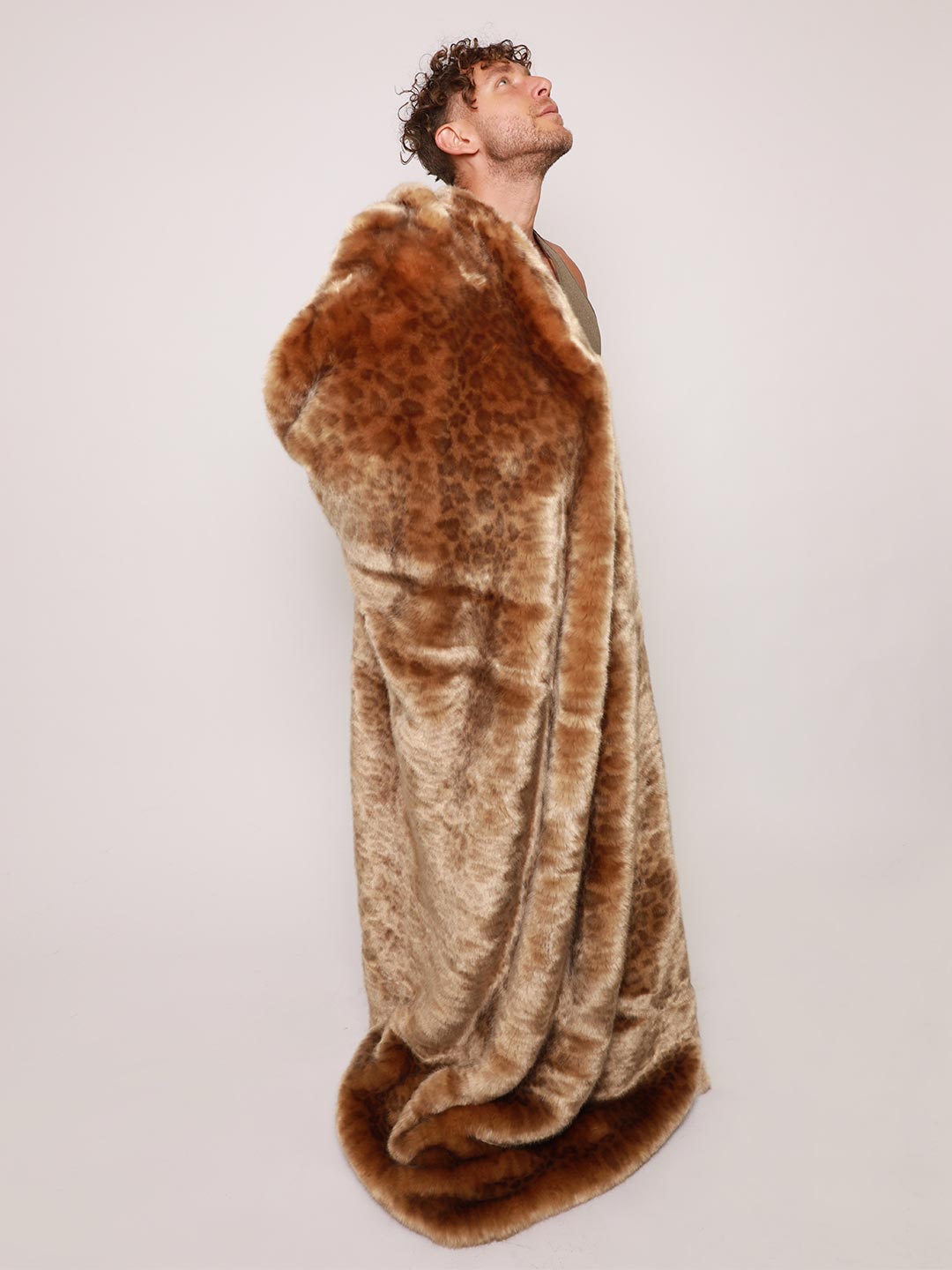Man Holding Luxe Faux Fur Throw in African Golden Cat Design