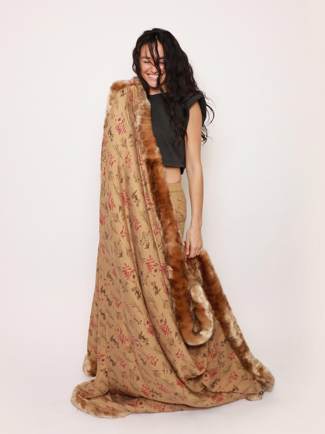 Woman Holding Luxe Faux Fur Throw in African Golden Cat Design