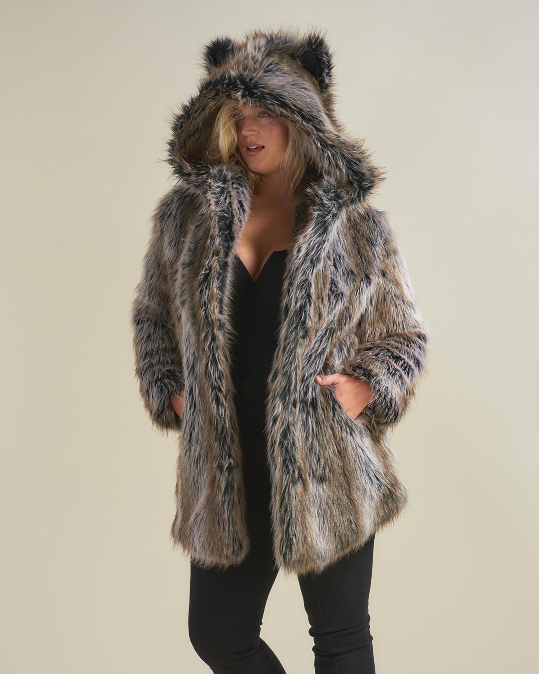 Blonde woman wearing Faux Fur Coat by SpiritHoods. Both her hands are in the coat pockets.