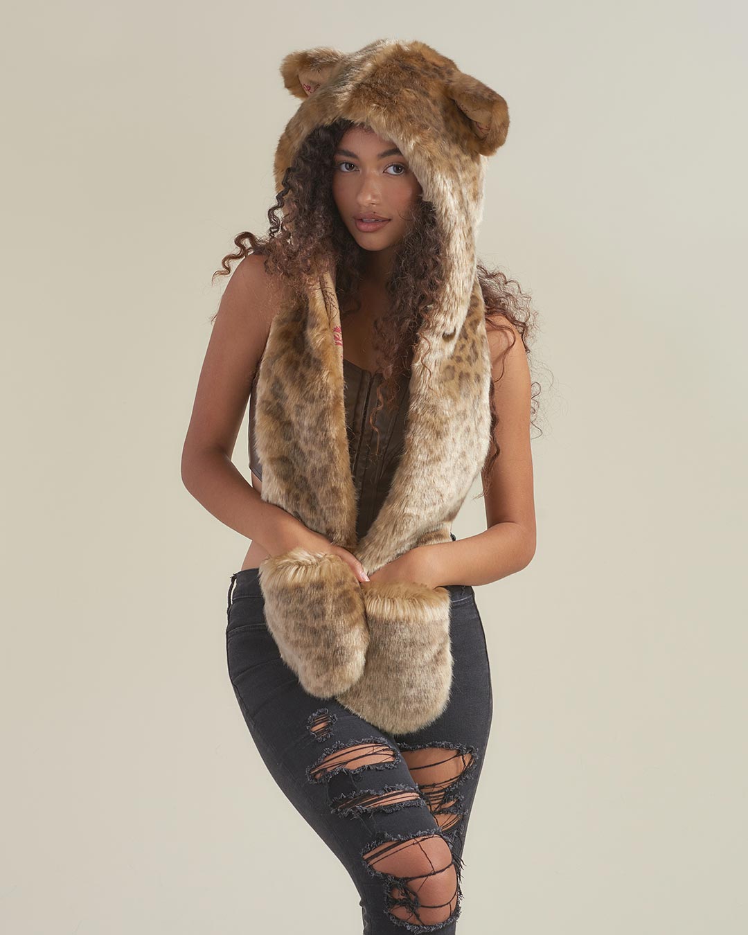 Woman wearing African Golden Cat Luxe Faux Fur Collector Edition Hood, front view 1