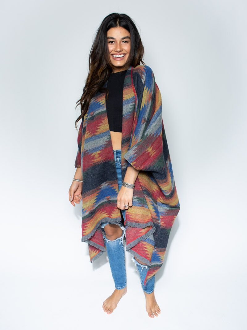 Woman wearing Dire Wolf Fabric Poncho, front view 