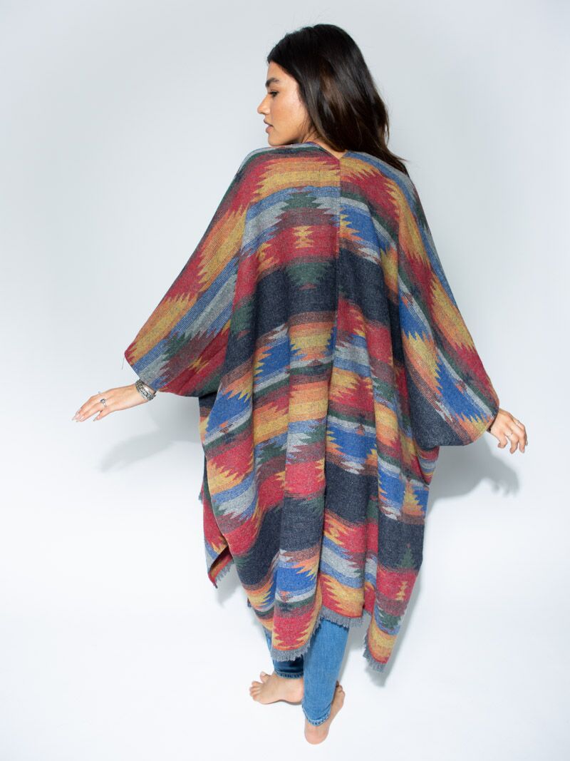 Woman wearing Dire Wolf Fabric Poncho, back view 