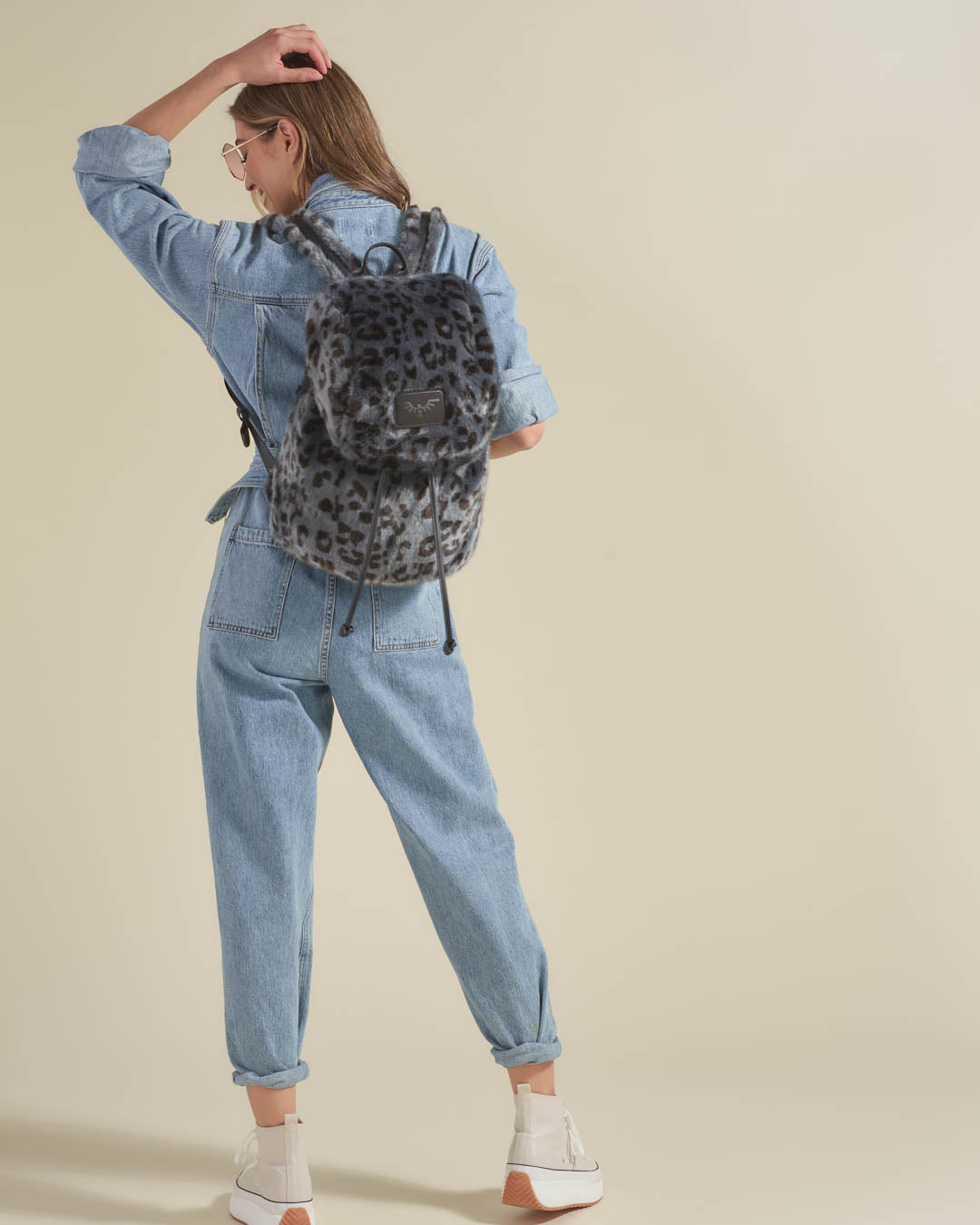 Woman Wearing Faux Fur Backpack in Slate Leopard Design