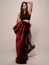 Woman wearing faux fur Luxury Garnet Throw, front view