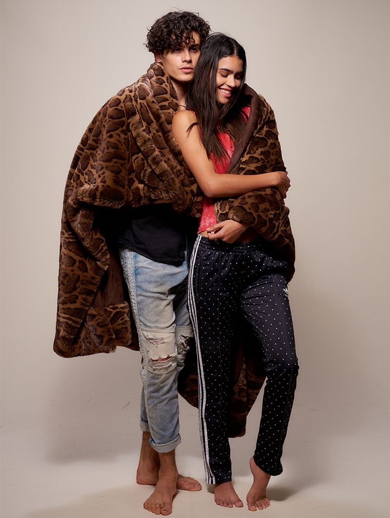 Male and Female Models Wrapped in Luxury Leopard Throw 