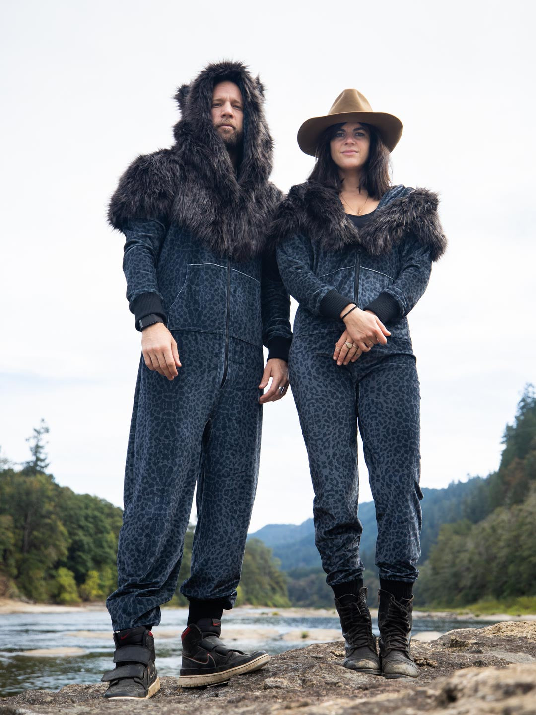 Man and Woman Standing Near Lake to Model the Black Panther Velvet Classic Faux Fur Animal Onesie