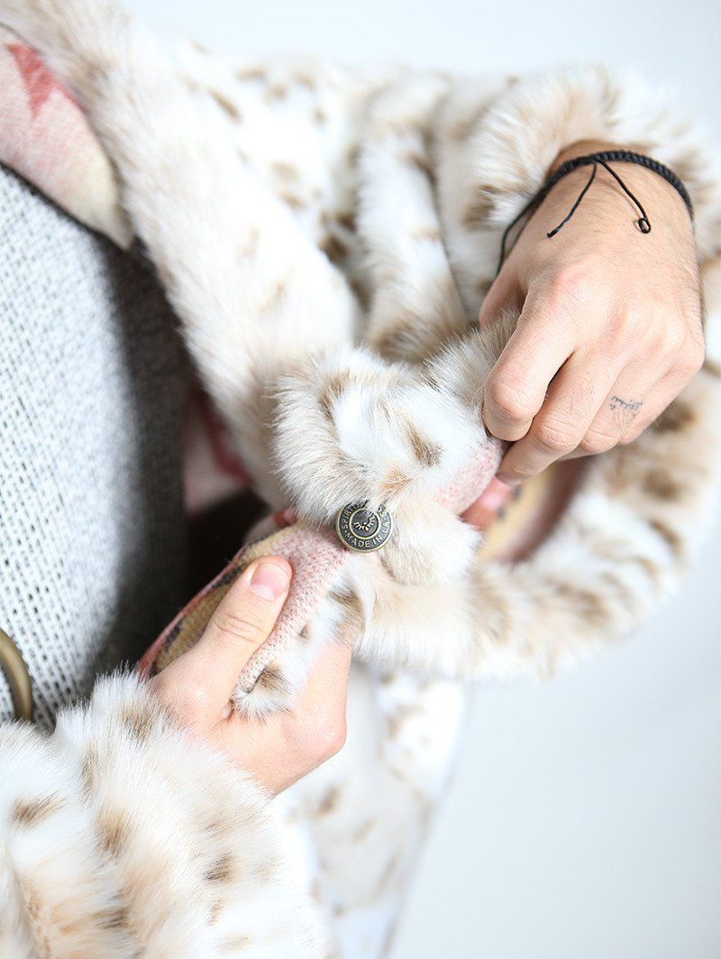 Close Up of Custom Button on Siberian Snow Leopard Faux Fur Throw 