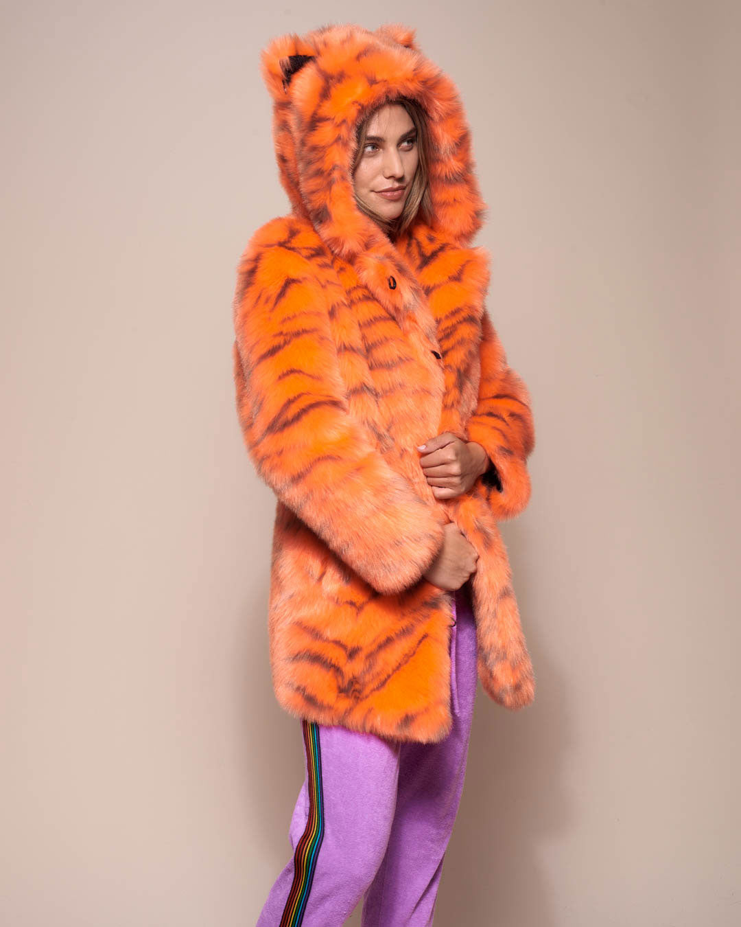 Woman wearing Neon Tiger Limited Edition Classic Faux Fur Coat, side view 2