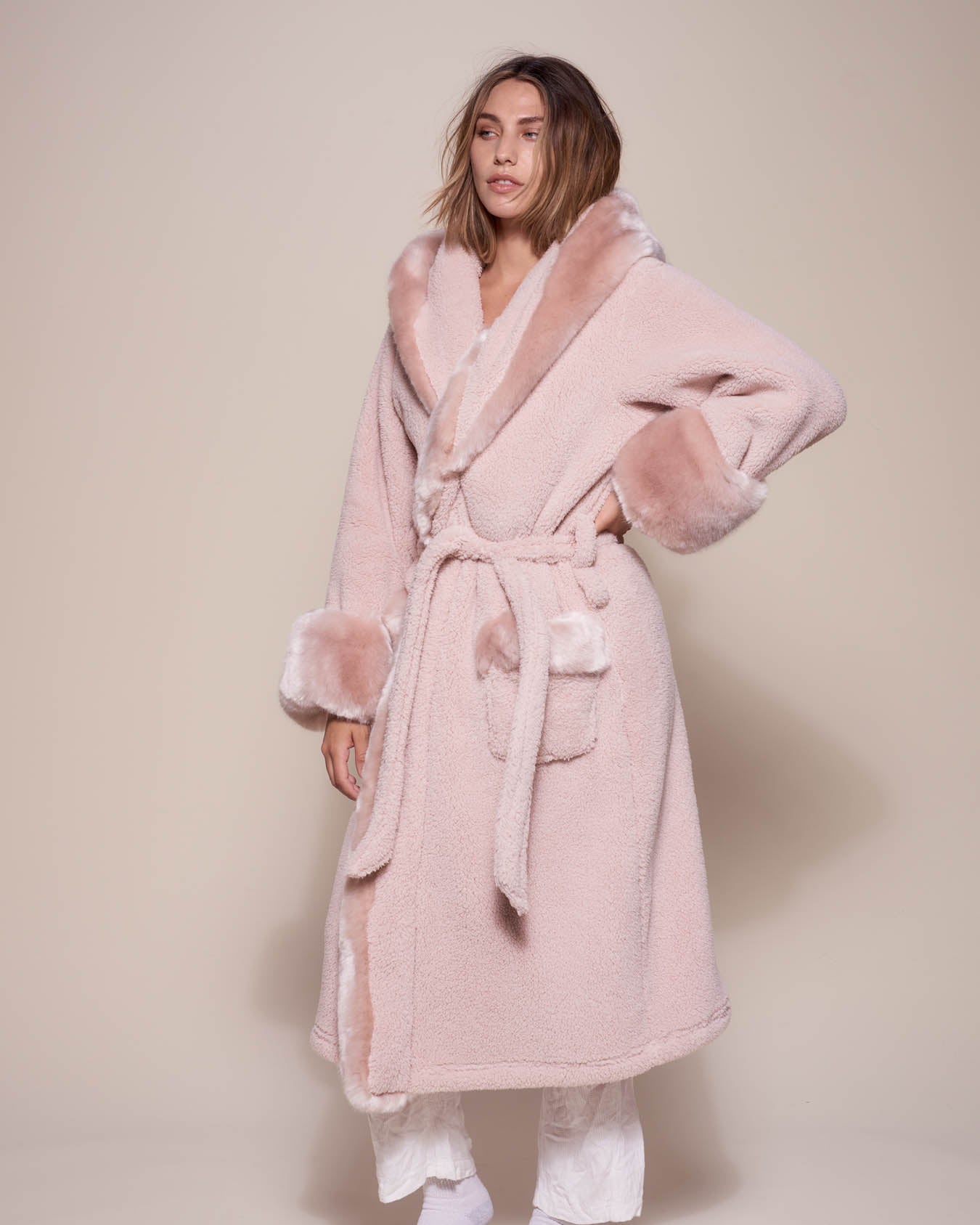 Woman wearing Rose Quartz Wolf Luxe Classic Faux Fur Robe, side view 2