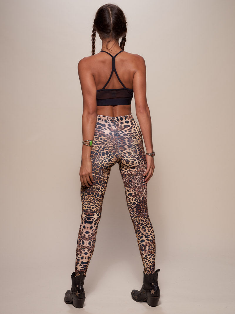 Woman wearing Amur Leopard Velvet Leggings, side view