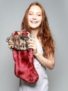 Woman holding faux fur Howliday Feline Spirit Stocking, front view 1
