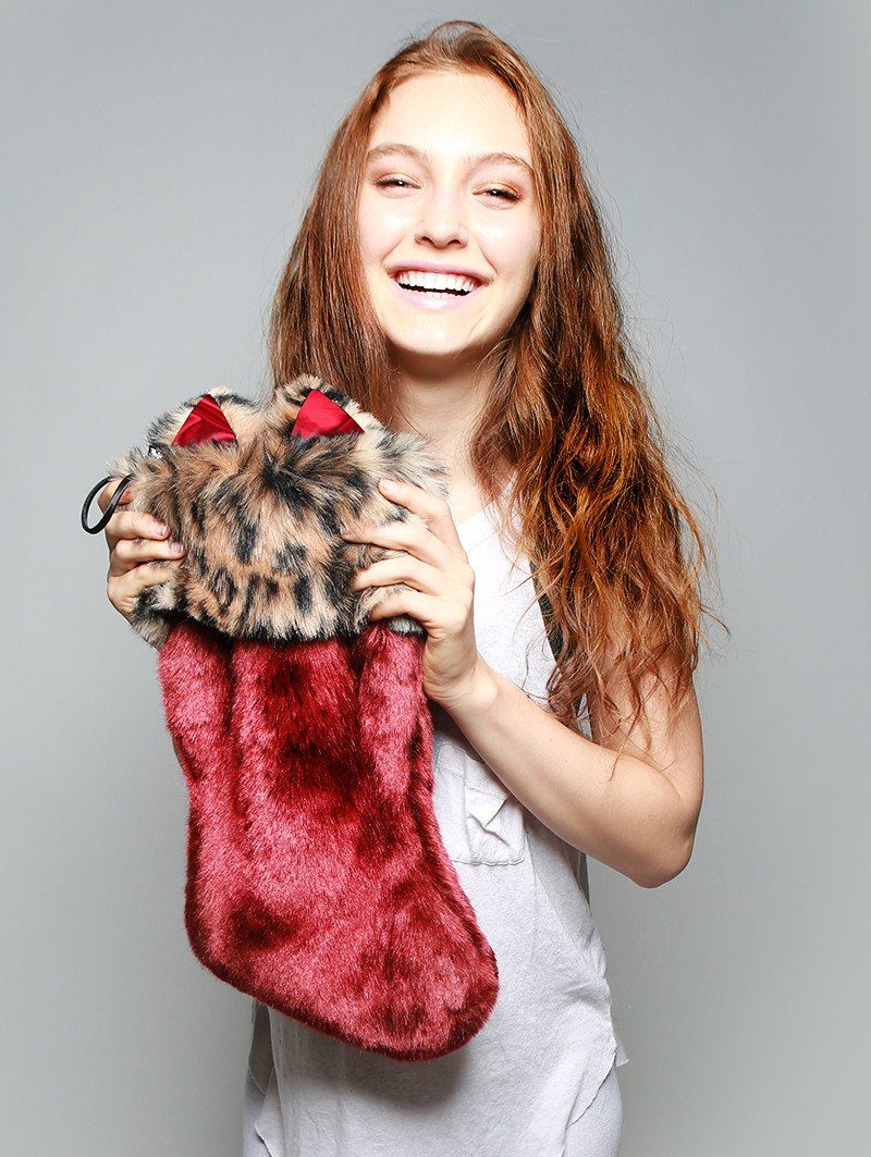 Woman holding faux fur Howliday Feline Spirit Stocking, front view 1