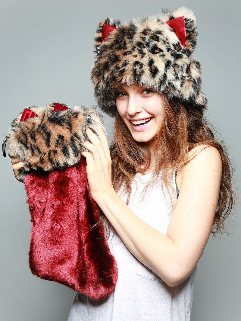 Women holding faux fur stocking and wearing faux fur hood, view 2