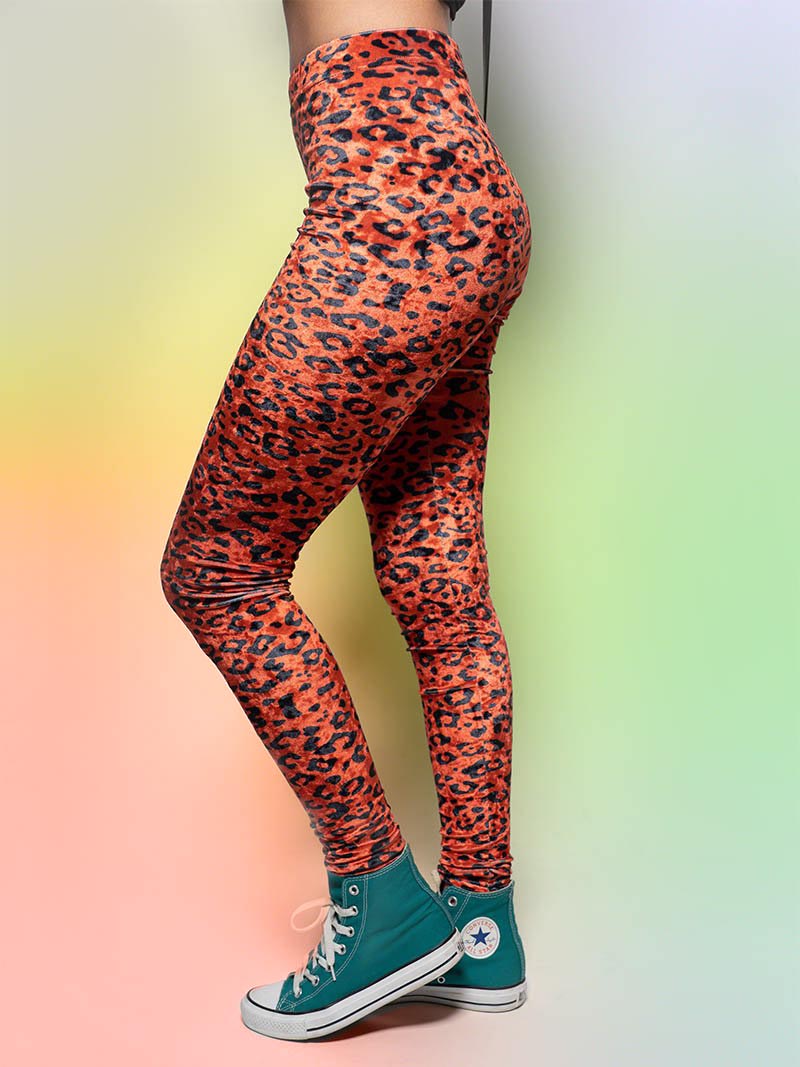 Woman Wearing Sunrise Cheetah Velvet Leggings and Turquoise High-Top Sneakers