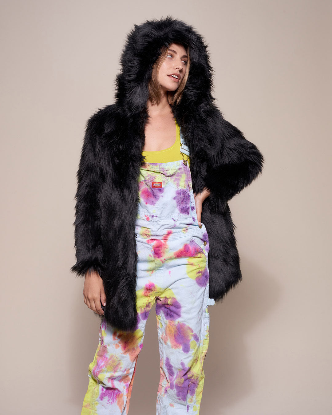 Woman Wearing Black Wolf Hooded Faux Fur Coat Over Her Pajamas