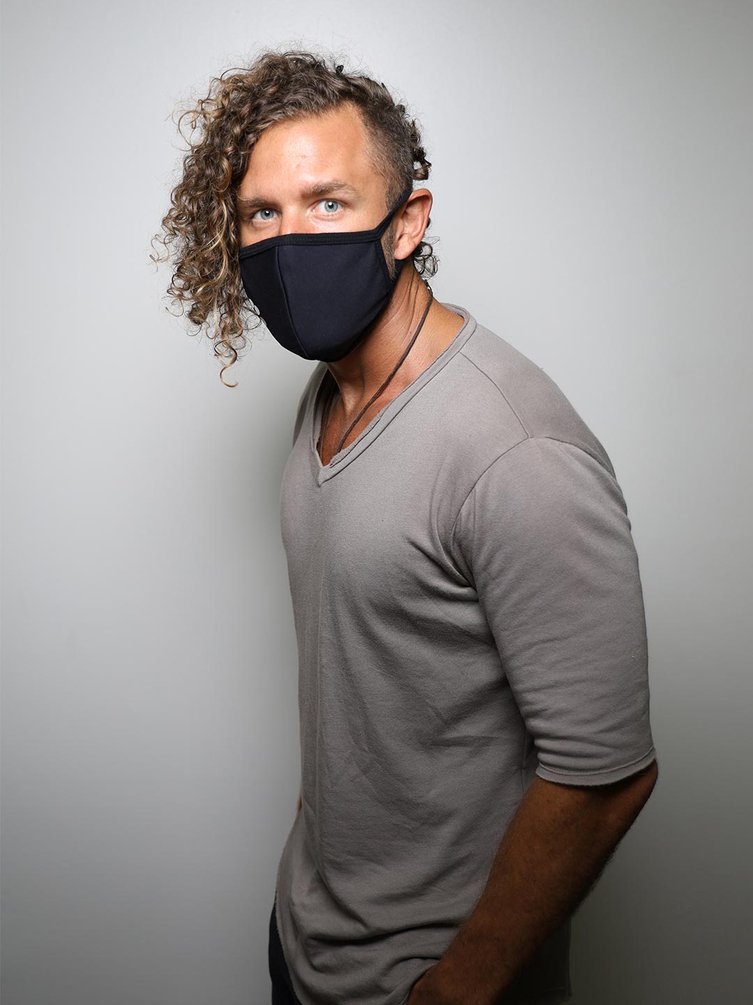 Man wearing Black Wolf Cloth Face Mask, side view