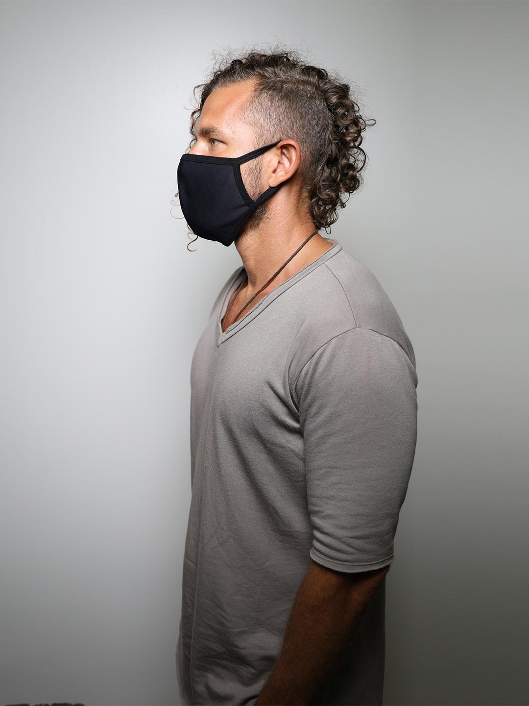 Man wearing Black Wolf Cloth Face Mask, side view 2