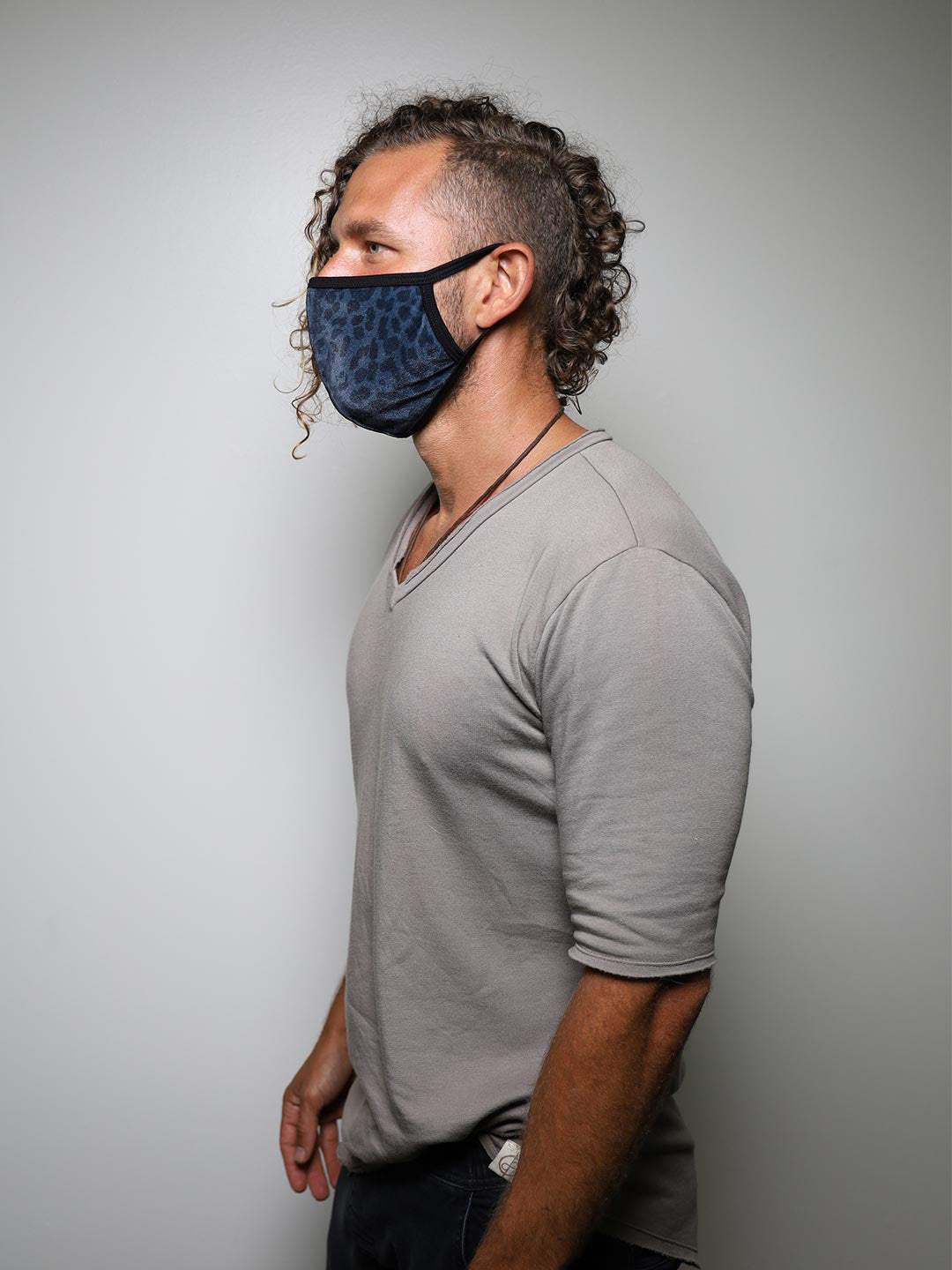 Man wearing Black Panther Cloth Face Mask, side view 1