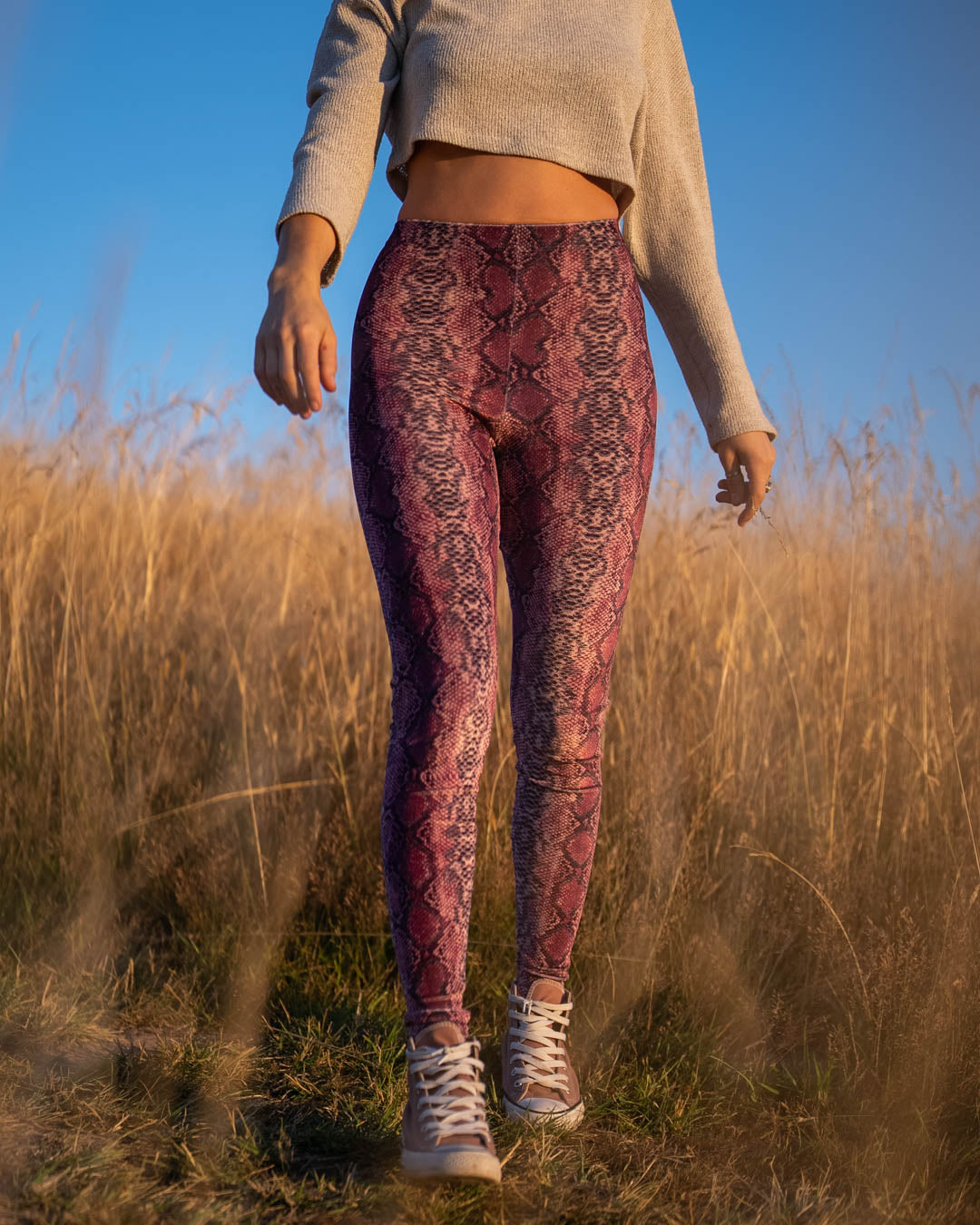 Woman in Pink High-Waisted Velvet Leggings in Python Design